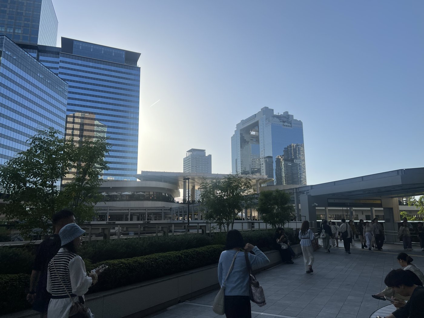 A pedestrian deck threading between Osaka's central train station towers — the everyday infrastructure that keeps the city moving.