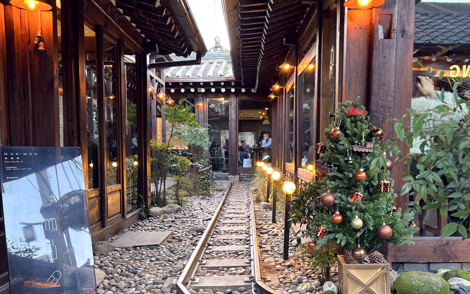 A hanok-lined lane in Seoul's Ikseon-dong — traditional tiled roofs now sheltering cafés and wine bars.