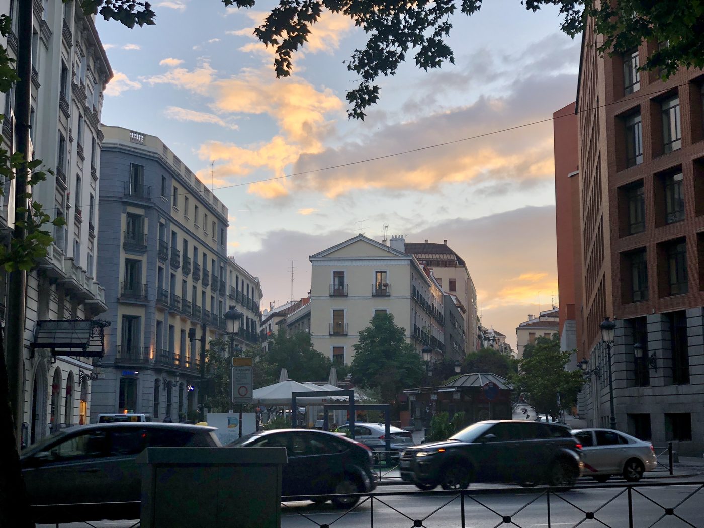 A Madrid street at sunset, near Plaza de España — the hour when the city's terraces start filling up.